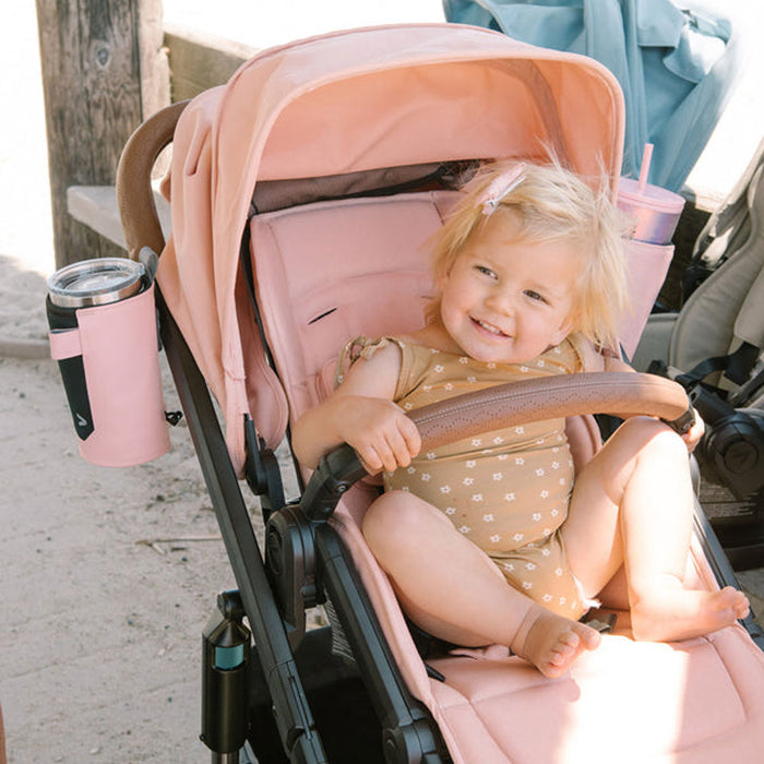 Little girl riding in Veer Switchback while holding onto Veer Switchback Seat Bumper Bar Leather Grips - Genuine Napa Leather - Saddle